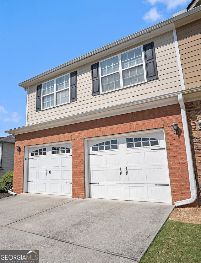 garage featuring concrete driveway