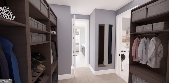 mudroom with baseboards, washer / dryer, and carpet flooring