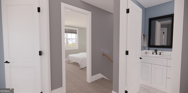 bathroom with ensuite bathroom, baseboards, and vanity