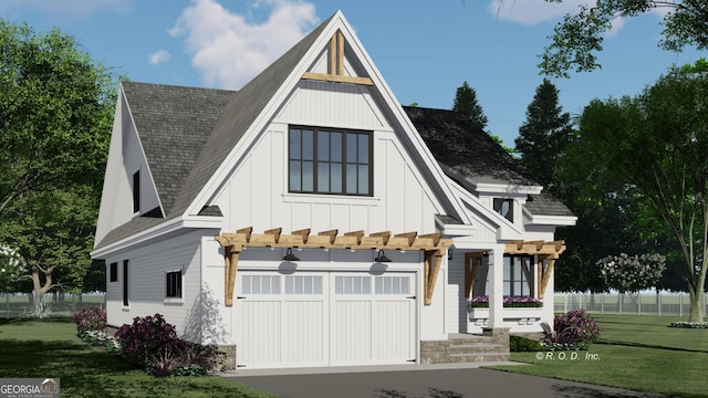 view of front of home with a front lawn, fence, board and batten siding, and a garage