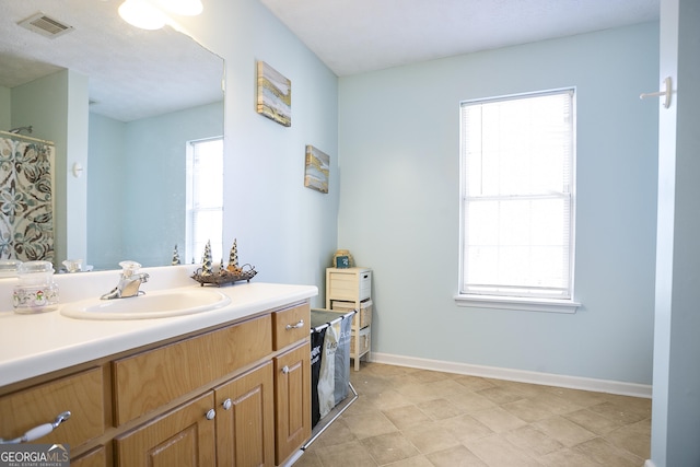 45 Hunters Ridge Ct, Covington, GA 30014 - full bathroom with a wealth of natural light, vanity, visible vents, and baseboards