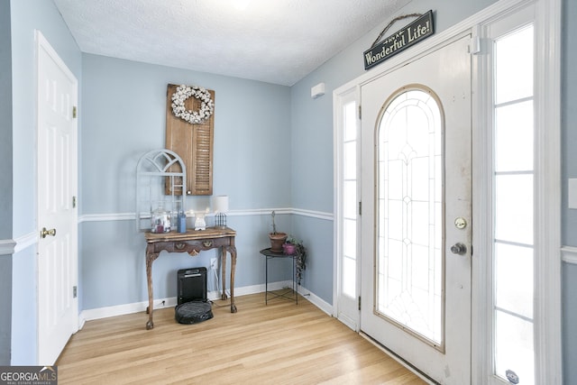 45 Hunters Ridge Ct, Covington, GA 30014 - entrance foyer with a textured ceiling, baseboards, and wood finished floors