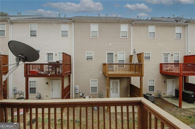 rear view of house featuring central AC unit