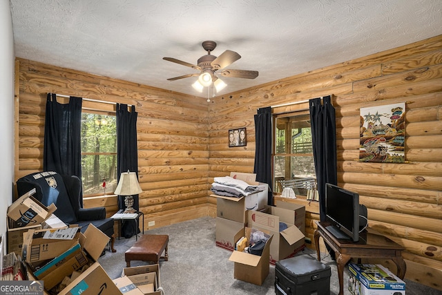 carpeted office space featuring a ceiling fan