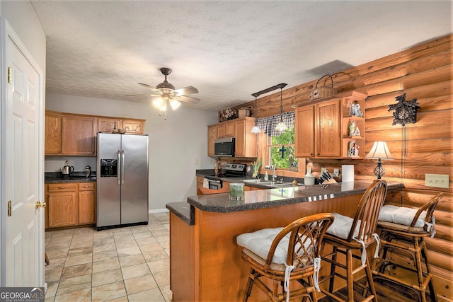 kitchen with a peninsula, brown cabinets, open shelves, a ceiling fan, and appliances with stainless steel finishes