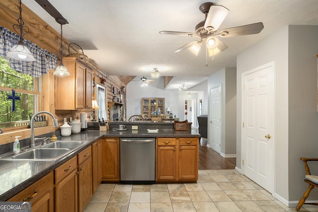 kitchen featuring a sink, a peninsula, brown cabinets, dishwasher, and a ceiling fan