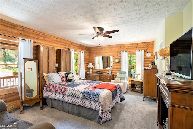 bedroom with light carpet, rustic walls, and a textured ceiling
