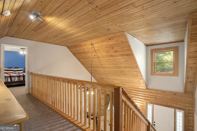 hallway with wooden ceiling, lofted ceiling, and carpet flooring