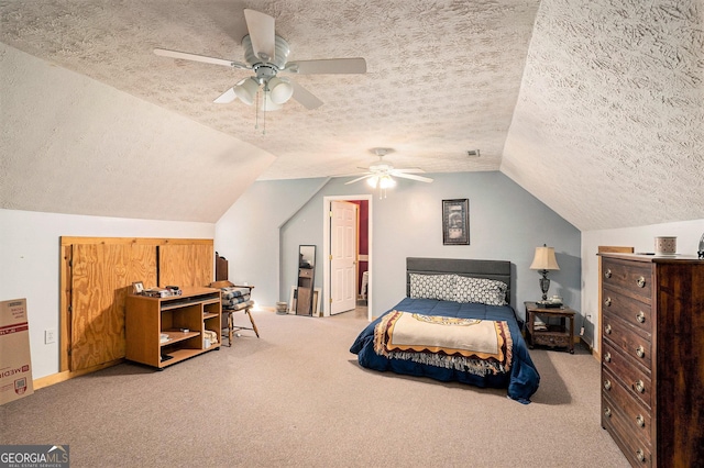 carpeted bedroom with lofted ceiling, a ceiling fan, visible vents, and a textured ceiling