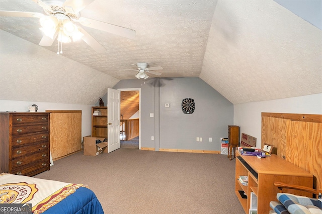 carpeted bedroom with a textured ceiling, baseboards, lofted ceiling, and ceiling fan