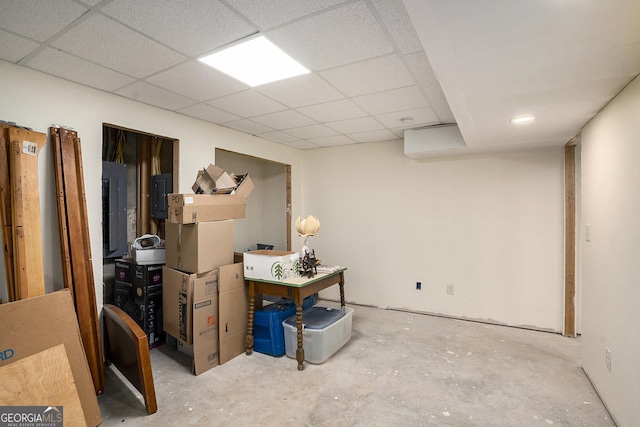 basement featuring electric panel and a drop ceiling
