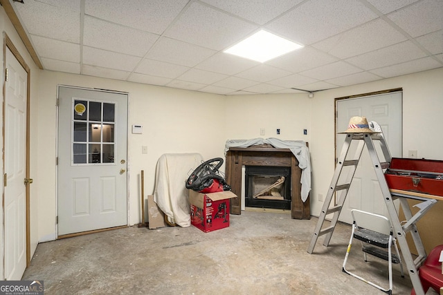 interior space with a paneled ceiling