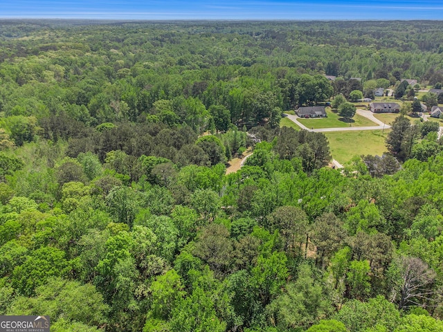 birds eye view of property featuring a view of trees