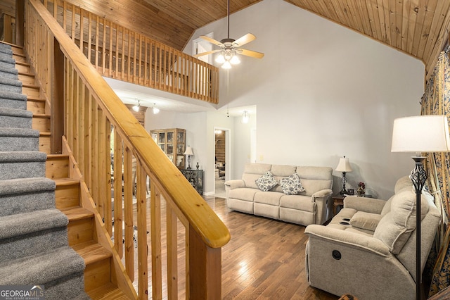 living area with ceiling fan, wood ceiling, stairs, high vaulted ceiling, and wood finished floors