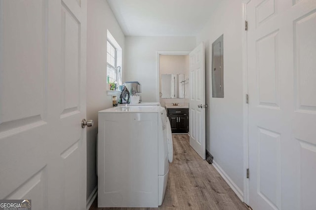 182 Hickory Dr, Ringgold, GA 30736 - washroom featuring light wood-style floors, electric panel, washing machine and dryer, and laundry area