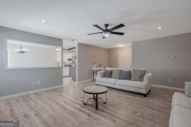 182 Hickory Dr, Ringgold, GA 30736 - living room featuring recessed lighting, light wood finished floors, ceiling fan with notable chandelier, and baseboards