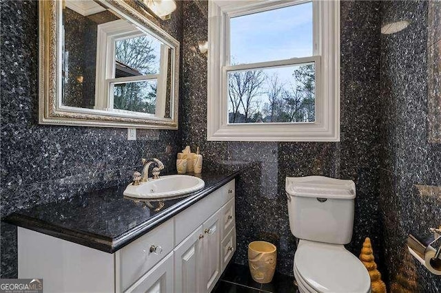 bathroom featuring toilet and vanity