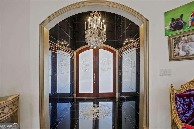 interior details with french doors, arched walkways, and a notable chandelier