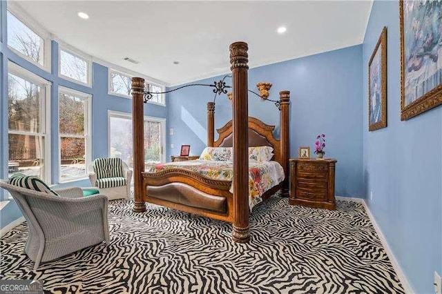 carpeted bedroom featuring recessed lighting, visible vents, and baseboards