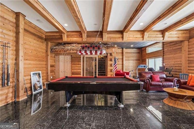 game room featuring beamed ceiling, billiards, granite finish floor, and rustic walls