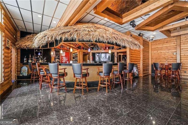 bar featuring a bar and log walls