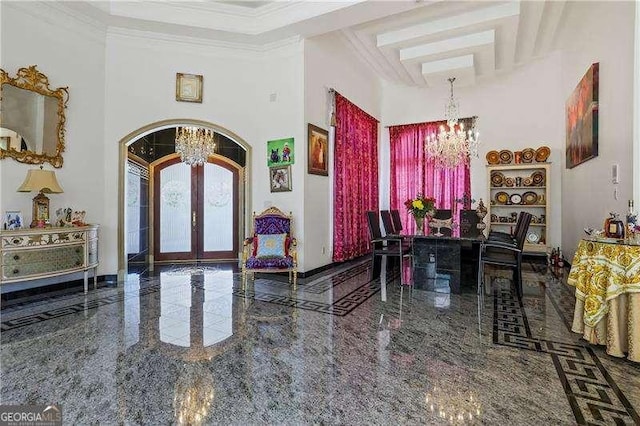 foyer featuring french doors, an inviting chandelier, and granite finish floor