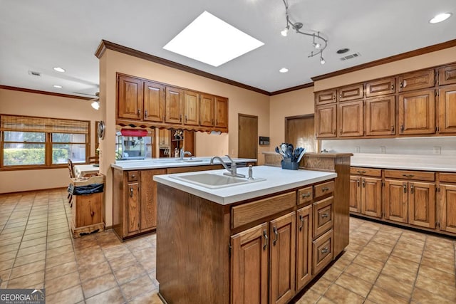 kitchen with a skylight, a sink, brown cabinets, ornamental molding, and recessed lighting