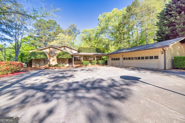 ranch-style house with an attached garage and driveway
