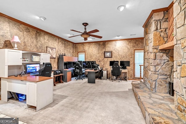 office with ceiling fan, crown molding, light colored carpet, and a fireplace