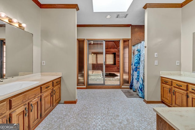 full bathroom featuring a skylight, baseboards, crown molding, two vanities, and curtained shower