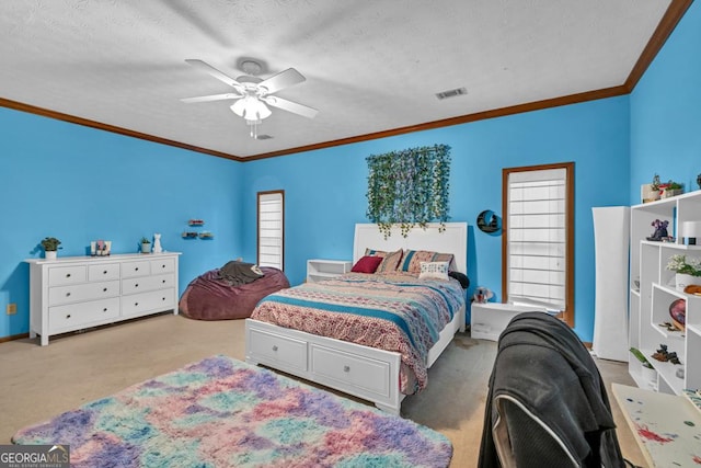 carpeted bedroom featuring crown molding and a ceiling fan