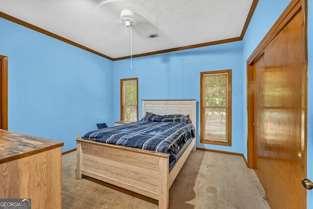 bedroom with carpet, baseboards, and crown molding