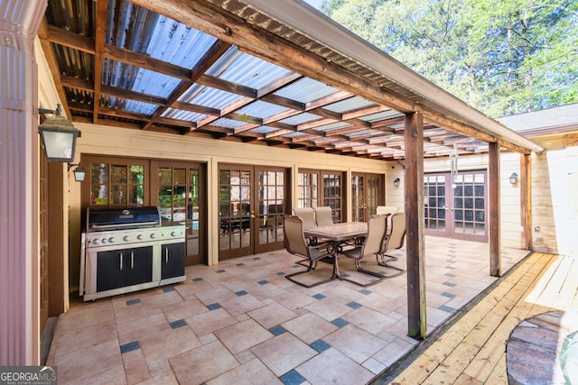 view of patio featuring french doors, area for grilling, a pergola, outdoor dining space, and a deck