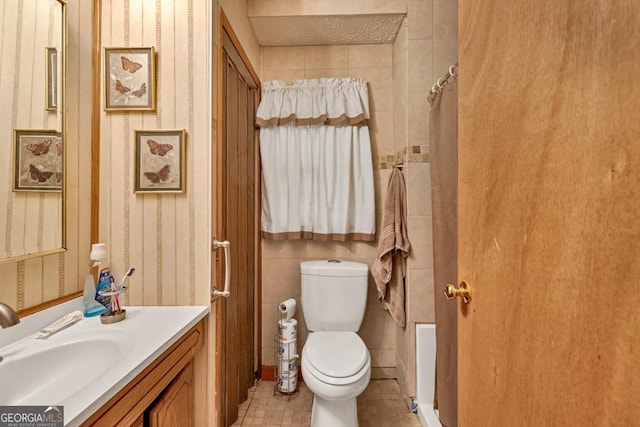 full bath with toilet, vanity, and tile patterned floors