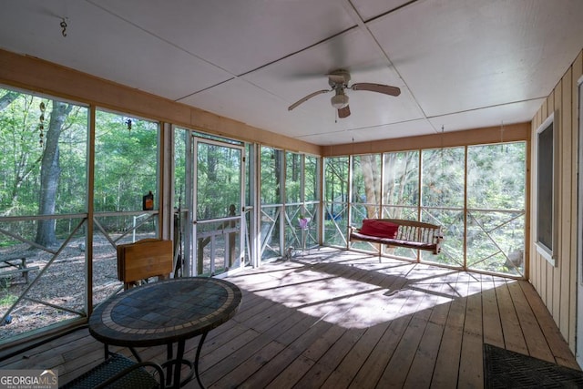 sunroom with a ceiling fan and plenty of natural light