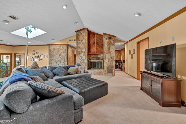 living room featuring a skylight, carpet floors, a stone fireplace, vaulted ceiling, and ornamental molding