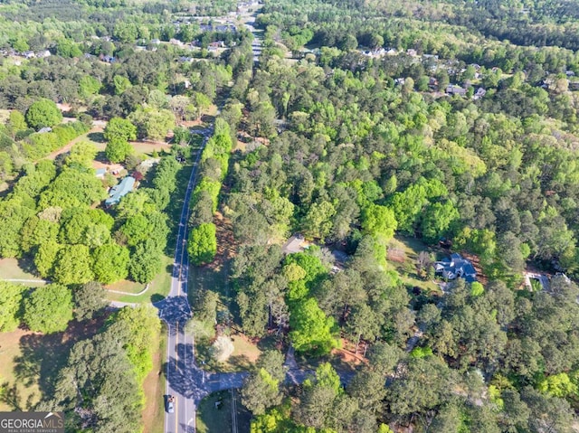 view of property location with a forest