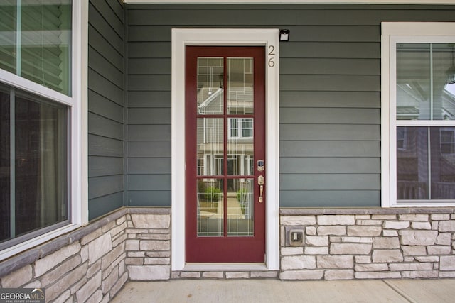entrance to property featuring stone siding