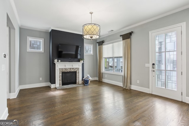 unfurnished living room with baseboards, ornamental molding, a fireplace, visible vents, and wood finished floors