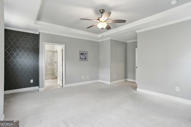 unfurnished bedroom with baseboards, a raised ceiling, and carpet