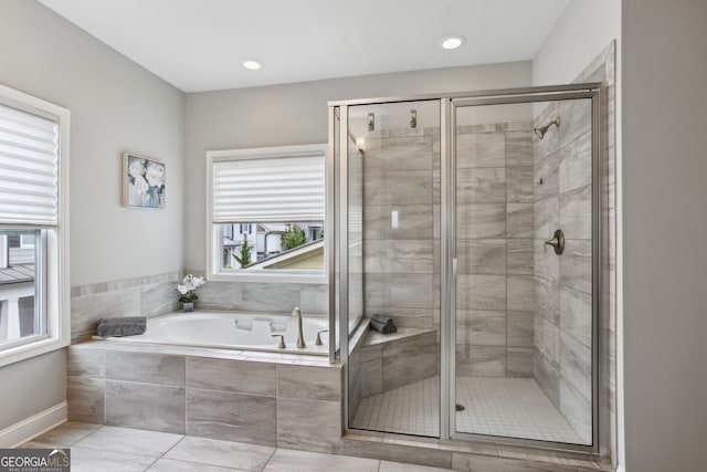 bathroom featuring a garden tub and a stall shower