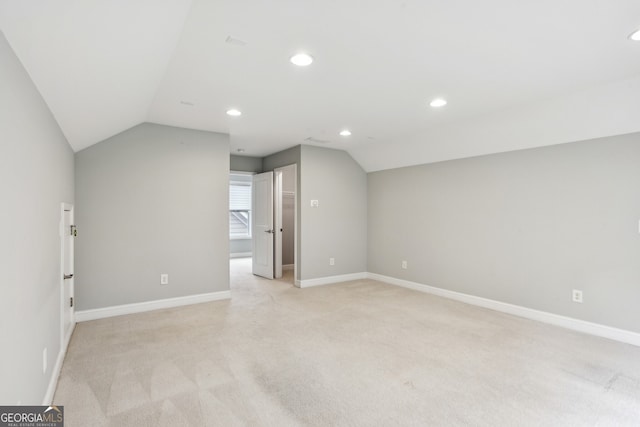 additional living space with baseboards, recessed lighting, light colored carpet, and lofted ceiling
