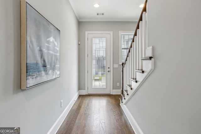 entryway with wood finished floors, baseboards, plenty of natural light, and stairway