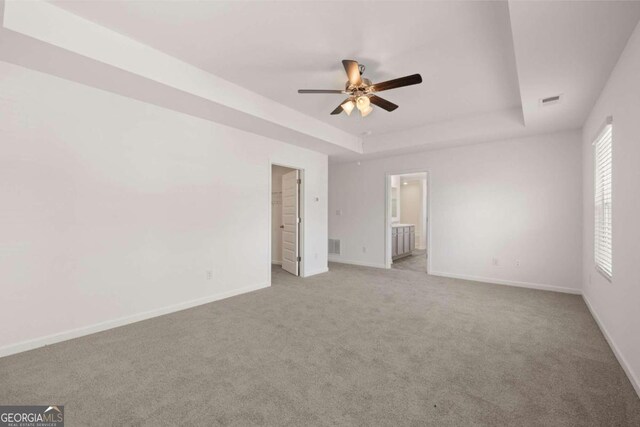 1612 Oakbrook Pond Pl, Dacula, GA 30019 - unfurnished bedroom with a tray ceiling, baseboards, and carpet