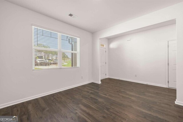 1612 Oakbrook Pond Pl, Dacula, GA 30019 - empty room with dark wood-style flooring and baseboards