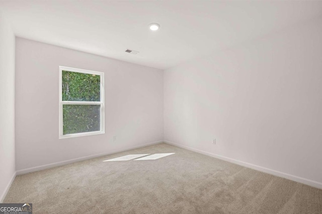 unfurnished bedroom featuring a closet, carpet floors, a spacious closet, and baseboards