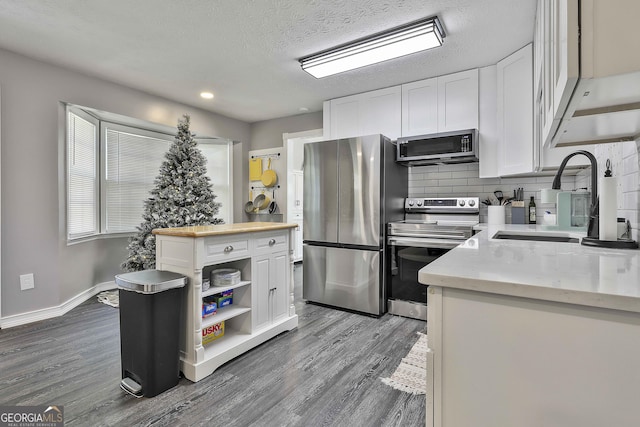 325 Sweetbriar Ln, Griffin, GA 30224 - kitchen featuring appliances with stainless steel finishes, white cabinetry, open shelves, dark wood finished floors, and a sink