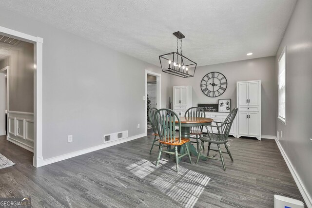 325 Sweetbriar Ln, Griffin, GA 30224 - dining area with visible vents, baseboards, a textured ceiling, and dark wood-style floors