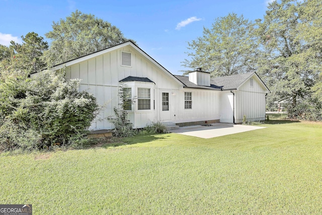 325 Sweetbriar Ln, Griffin, GA 30224 - rear view of property featuring a lawn, entry steps, roof with shingles, a patio area, and a chimney