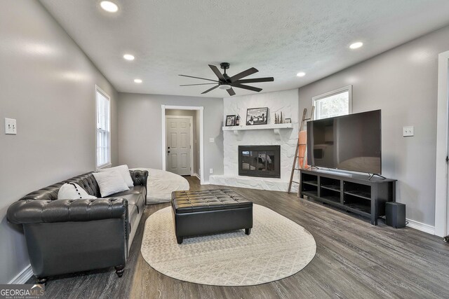 325 Sweetbriar Ln, Griffin, GA 30224 - living area featuring baseboards, a ceiling fan, a high end fireplace, a textured ceiling, and wood finished floors